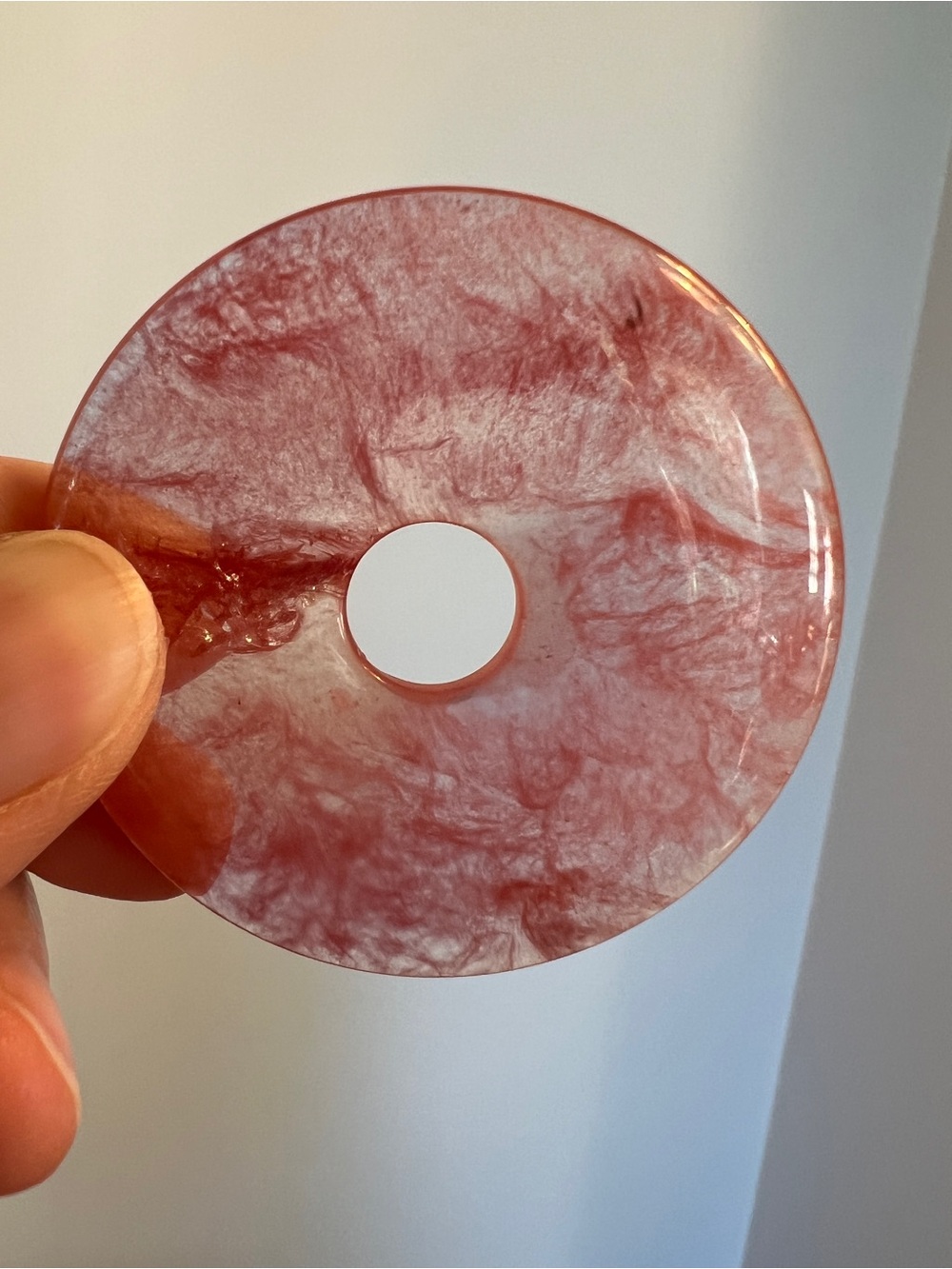 Clear quartz with pink veins throughout, for pendant wear or sphere stand.